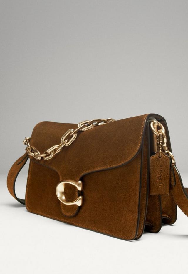 a brown purse with chain and a strap on a white background