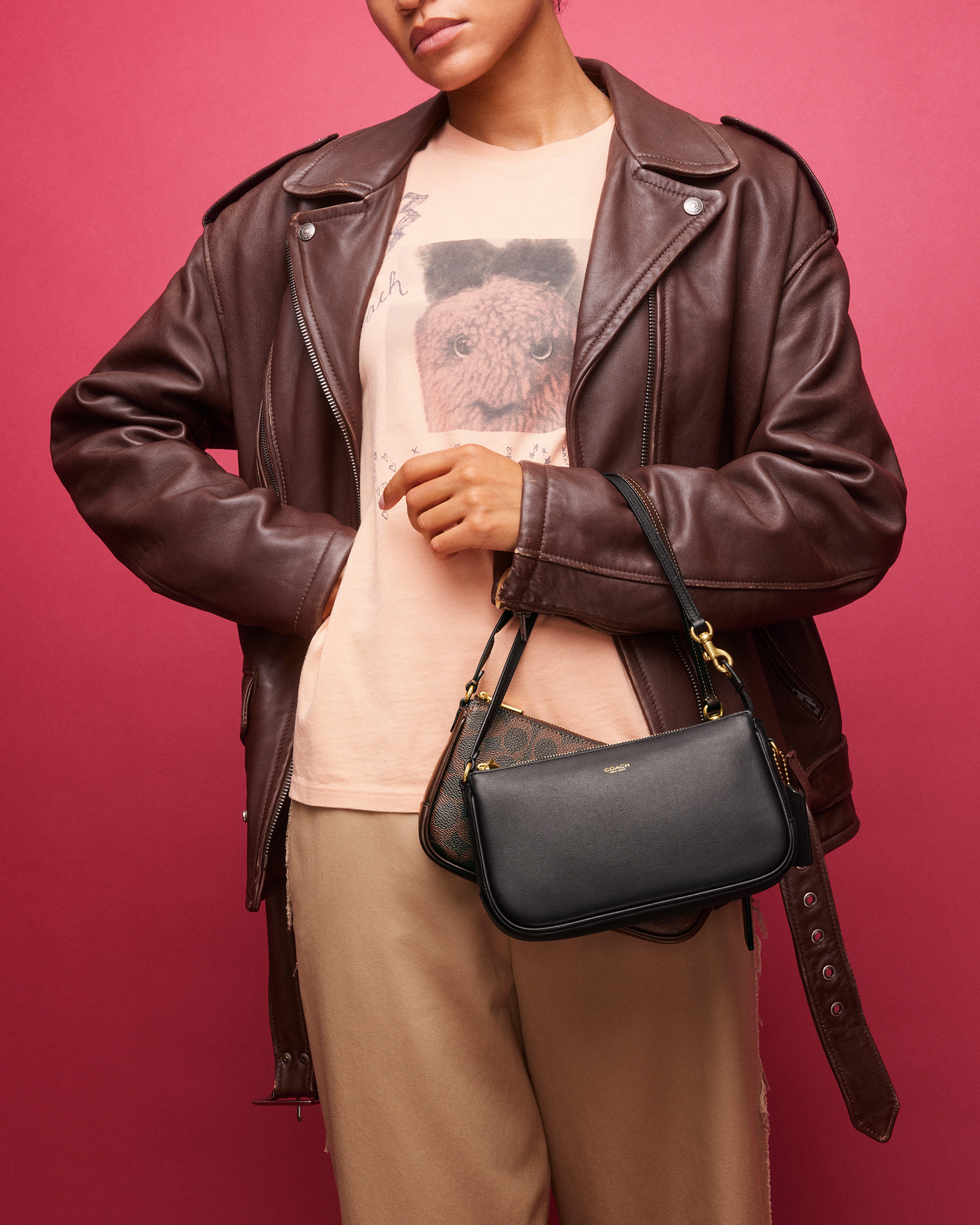 Model standing with shoulder bag