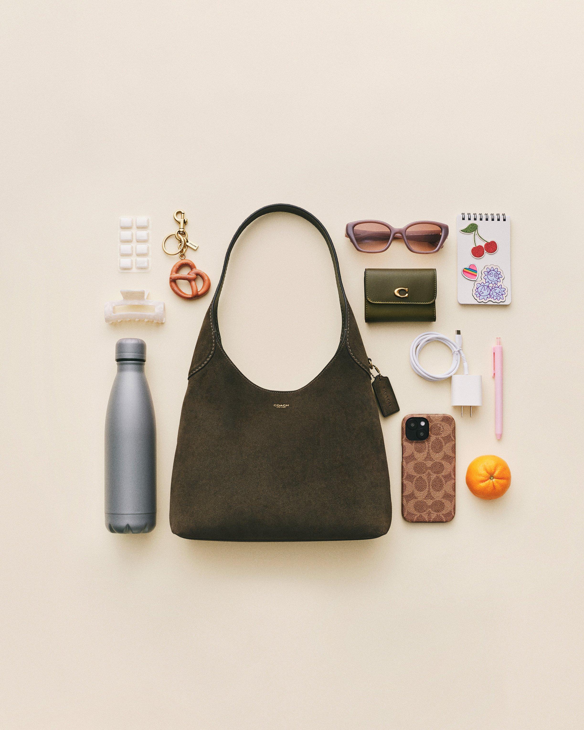 Model standing with shoulder bag