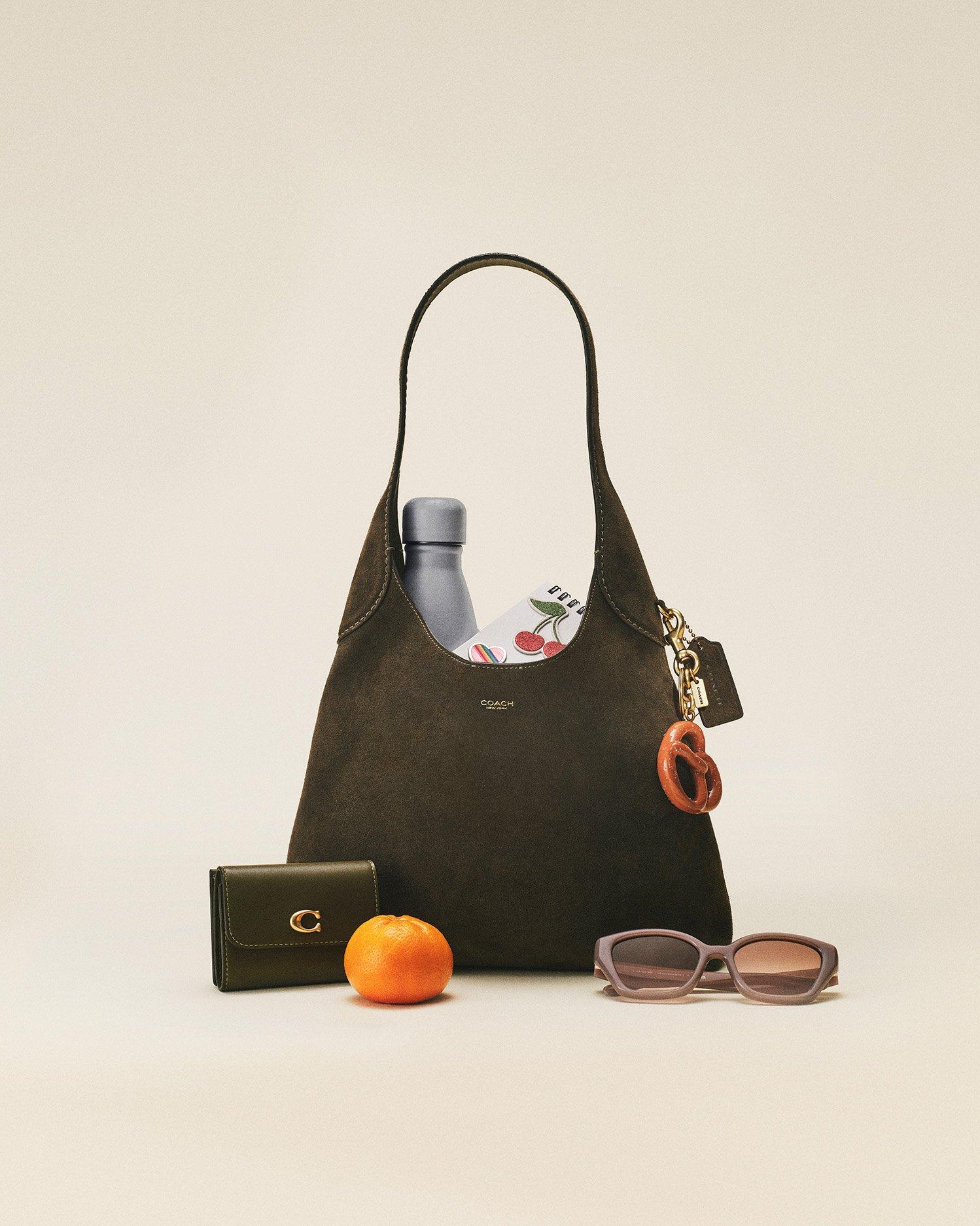 Model standing with shoulder bag