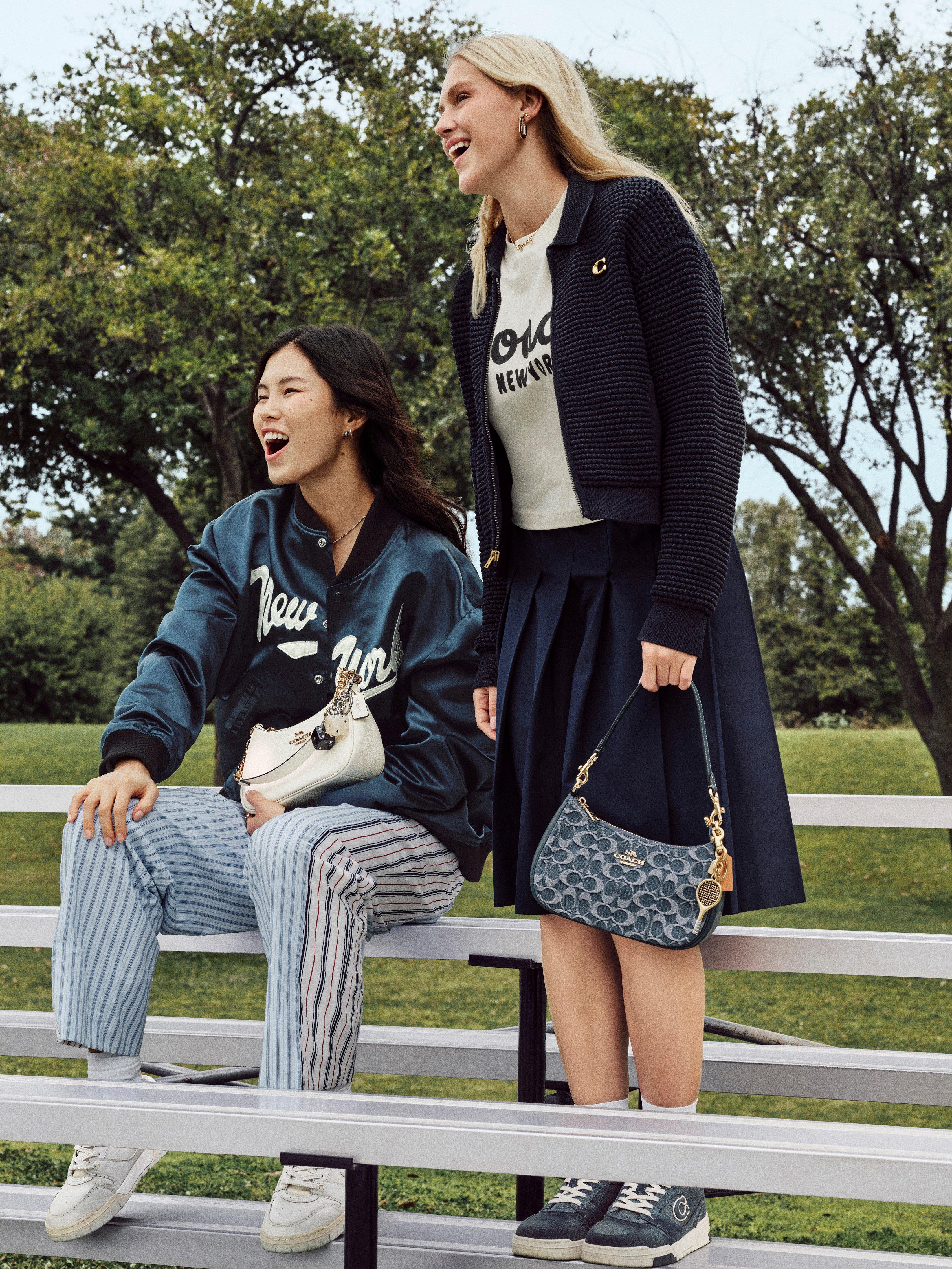 Model standing with shoulder bag