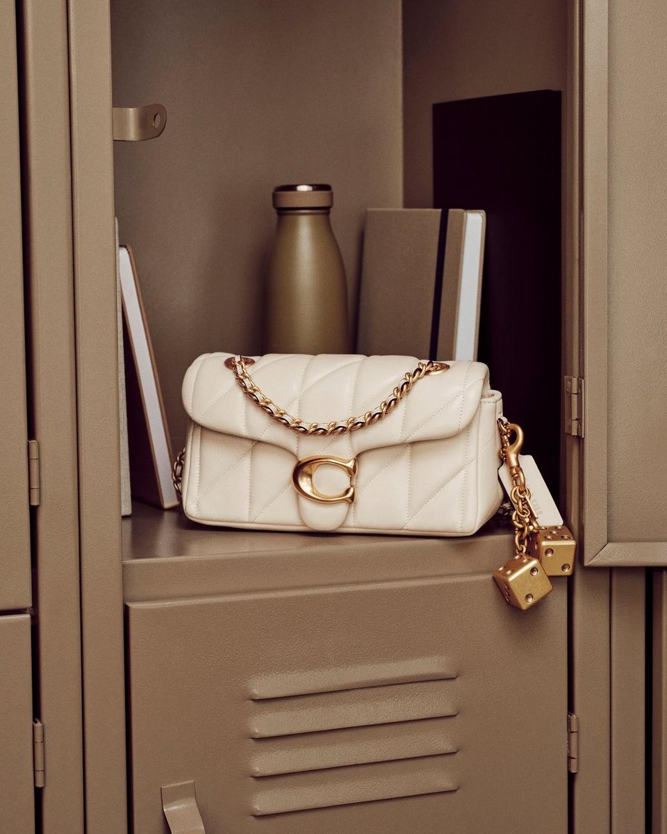 Model standing with shoulder bag