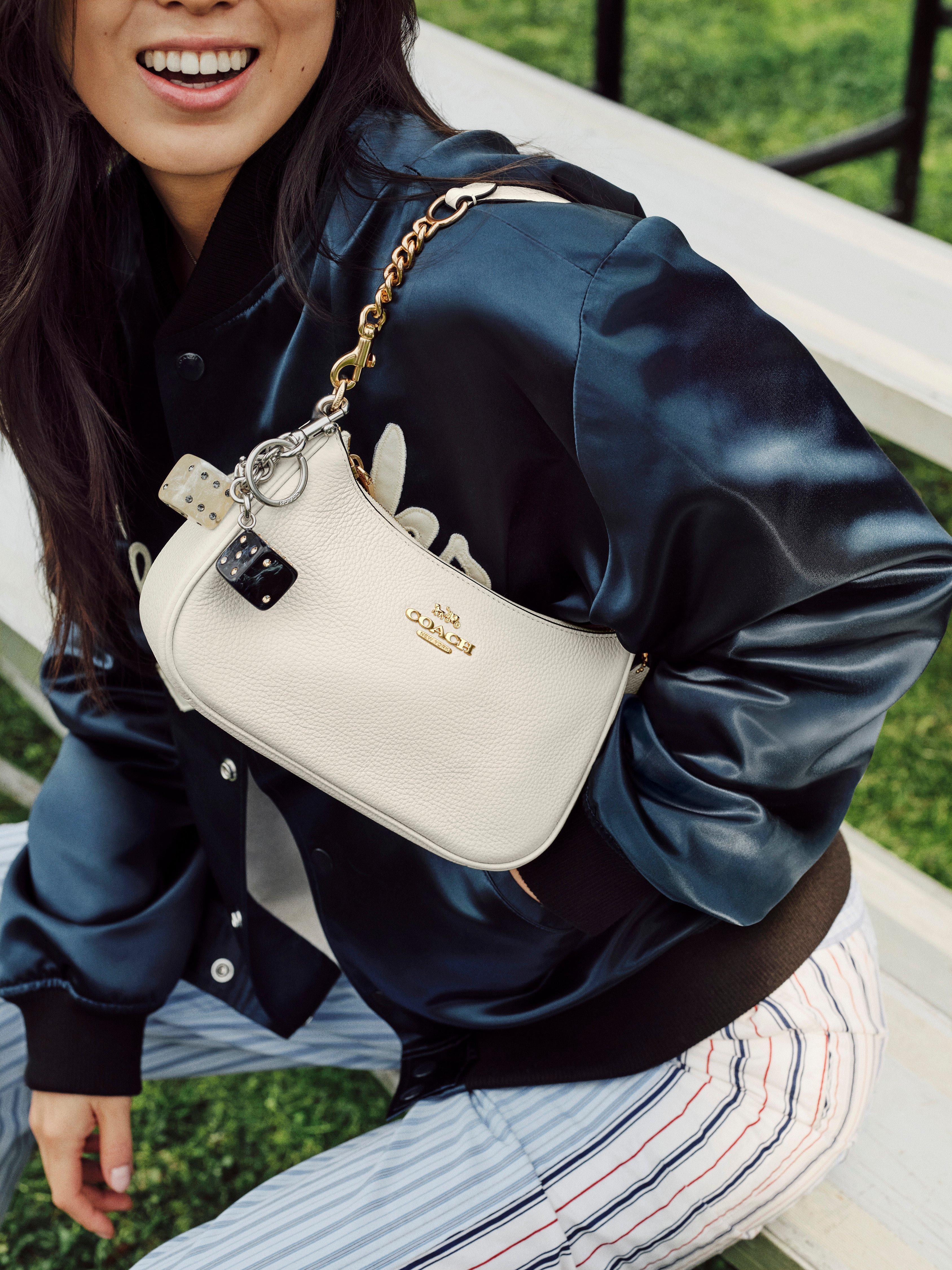Model standing with shoulder bag