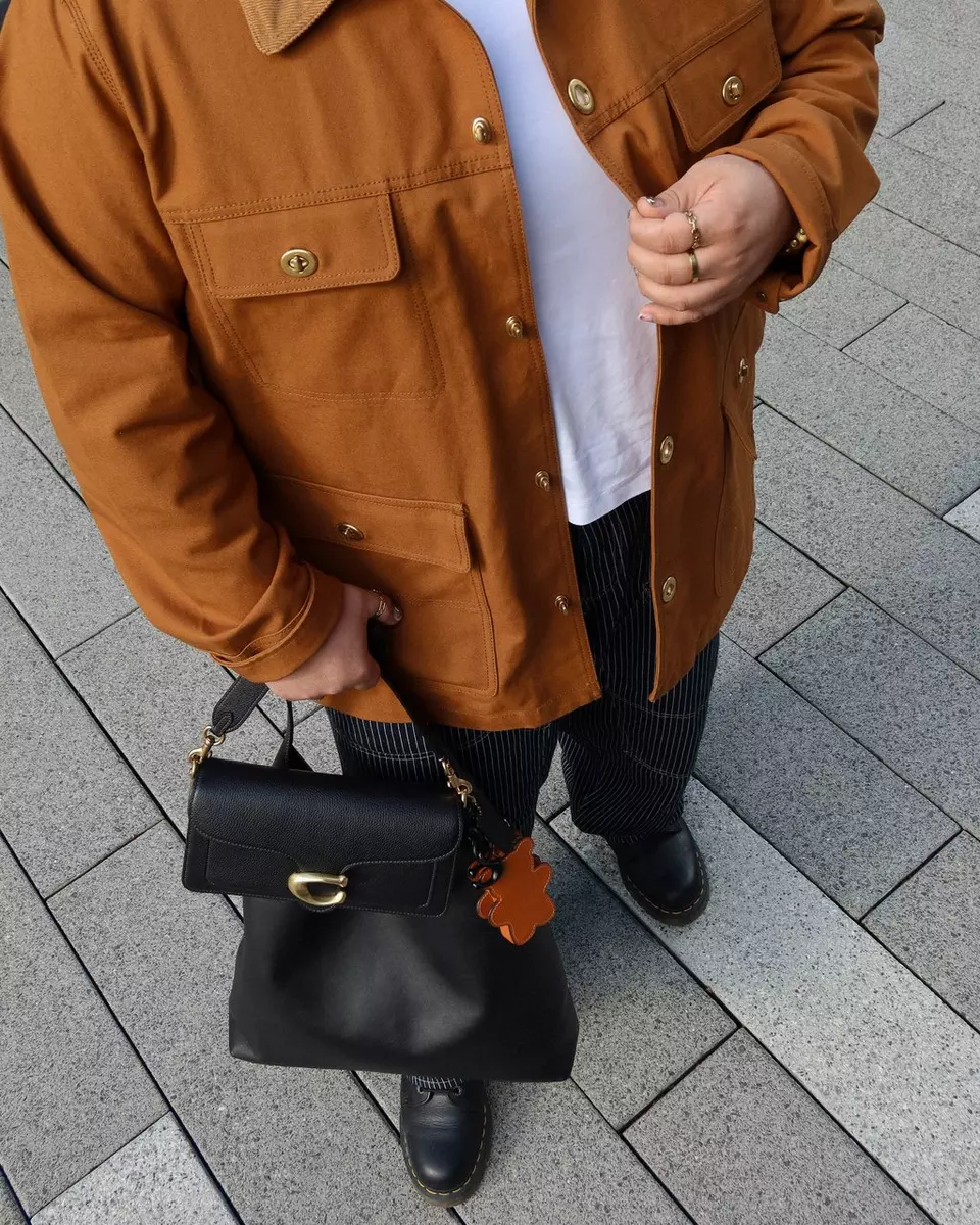 A man holding both coach tabby bag and brooklyn bag
