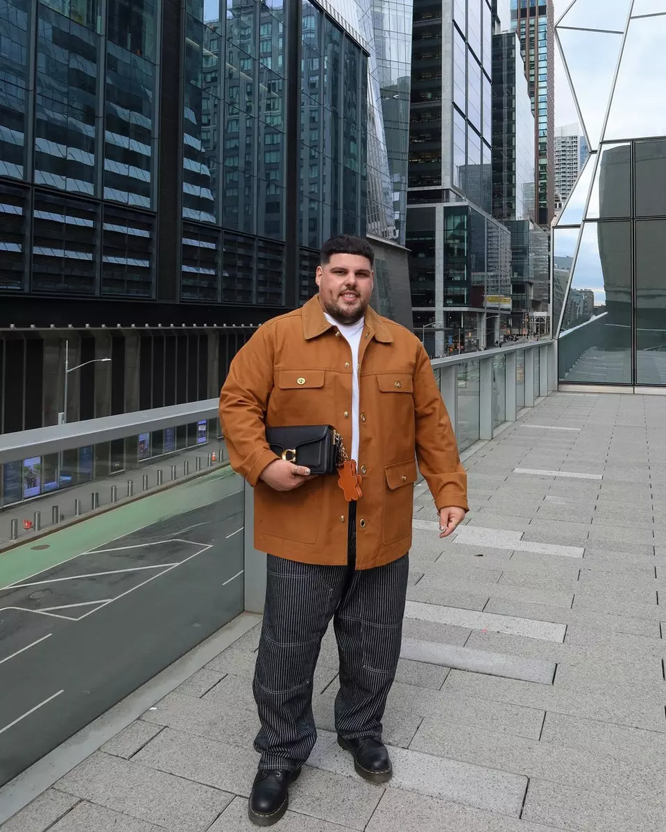 A man holding both coach tabby bag and brooklyn bag