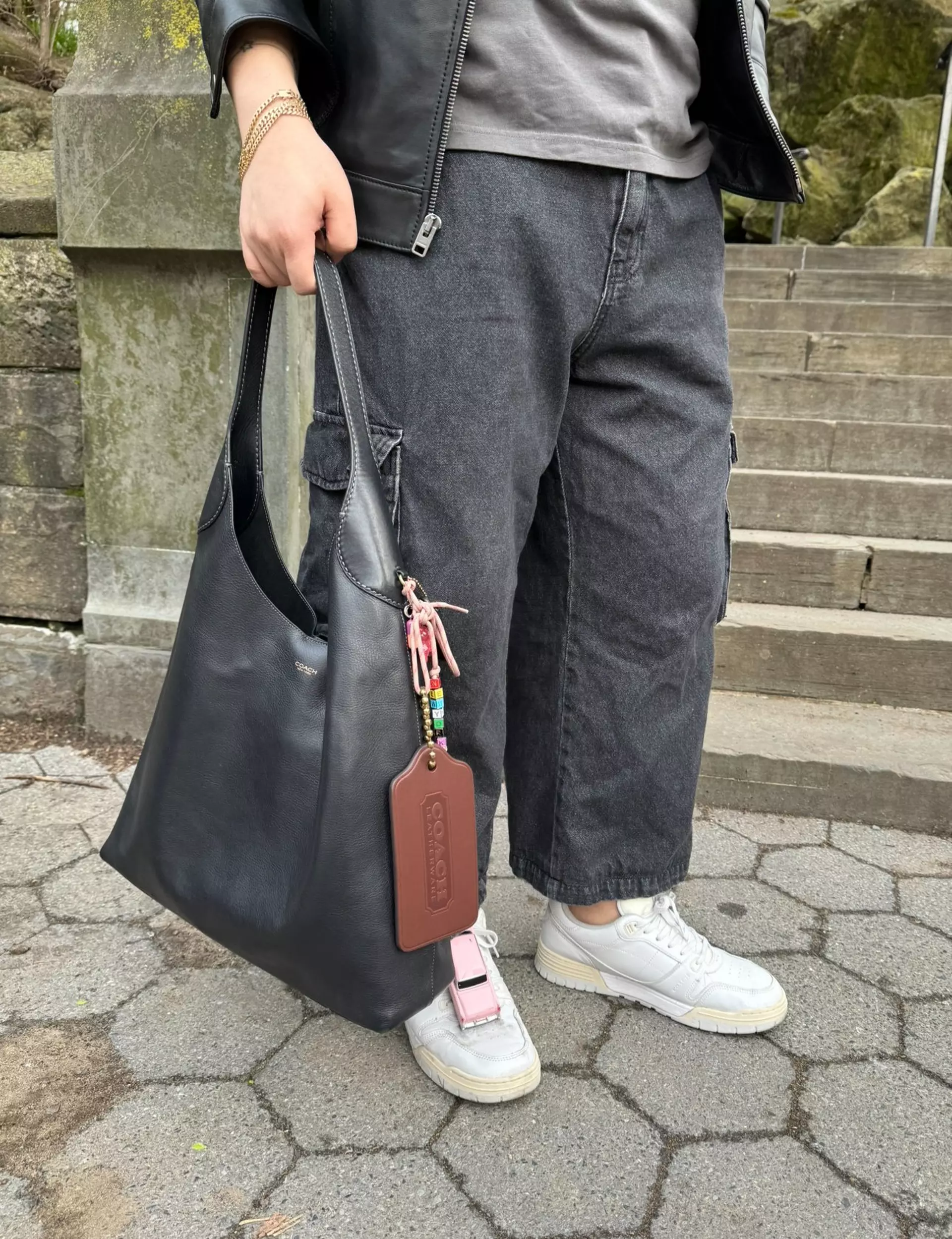 Model with a neutral handbag