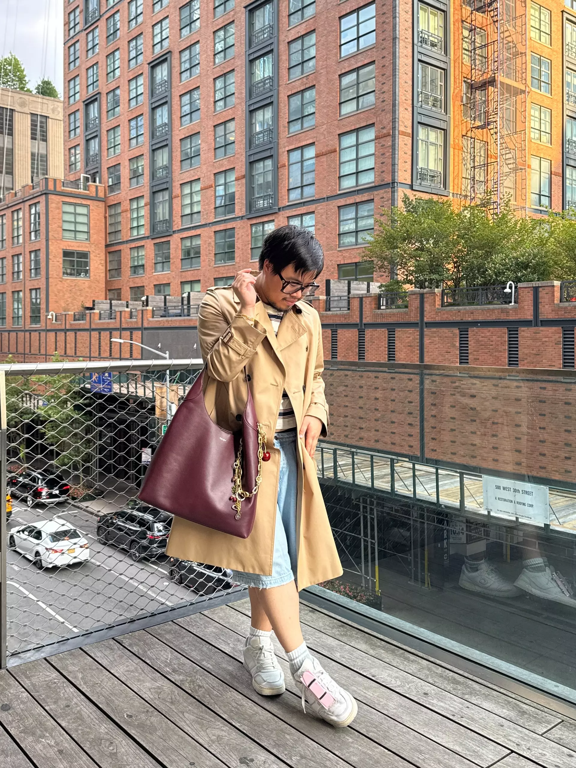 Model styling a neutral handbag