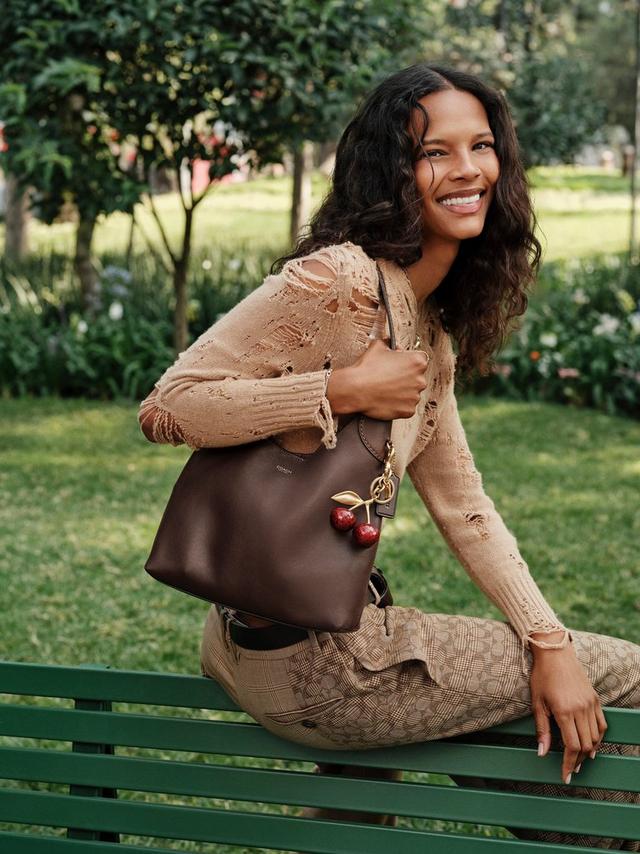 woman holding Coach Brooklyn bag