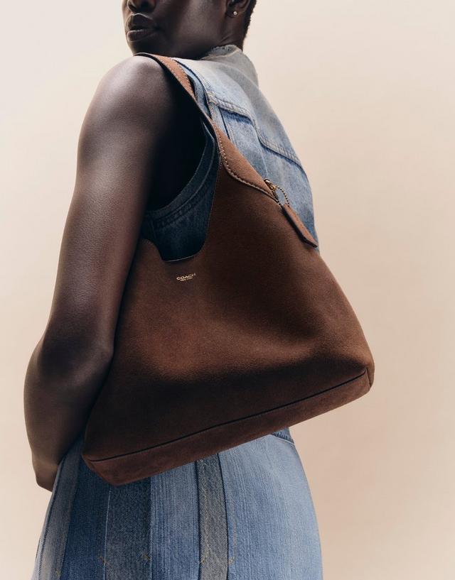 woman carrying Coach Brooklyn Shoulder Bag in chocolate suede