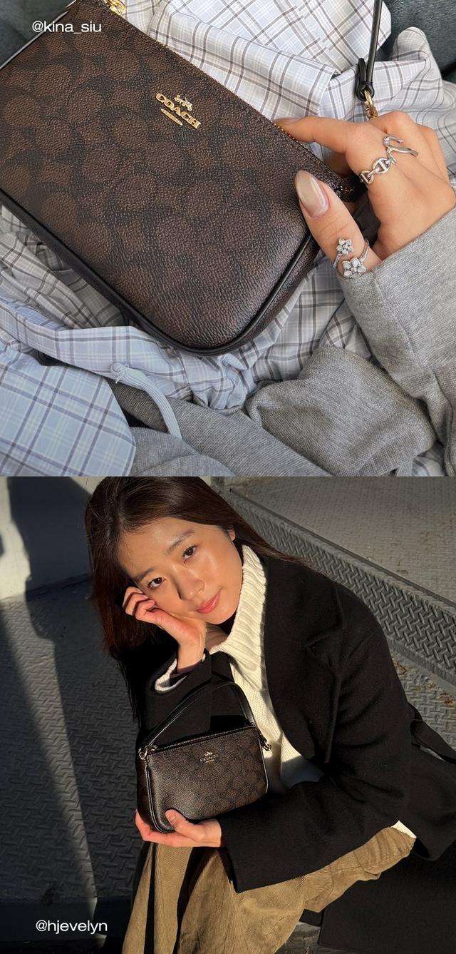 a woman sitting on a bench holding a coach purse