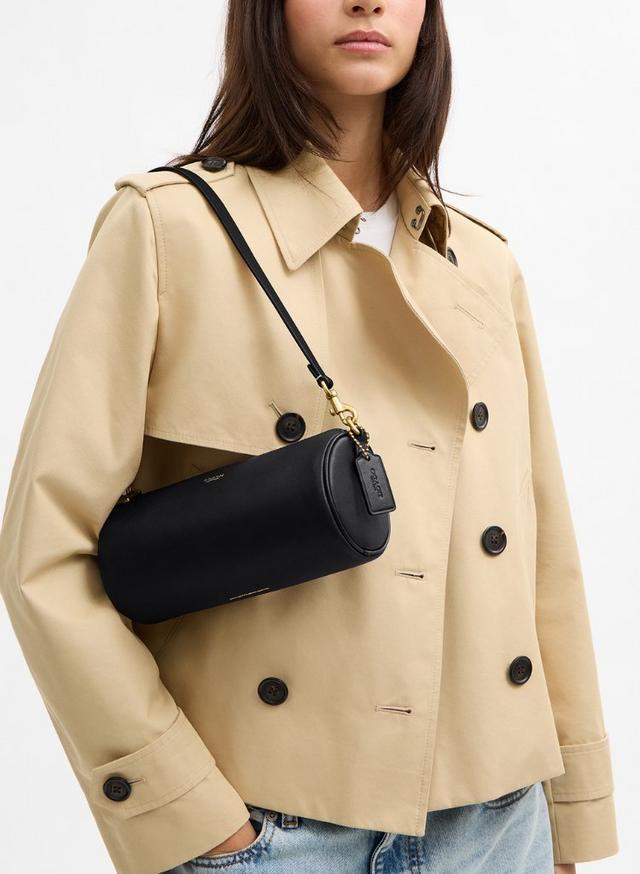 two women are standing next to each other holding Coach bags