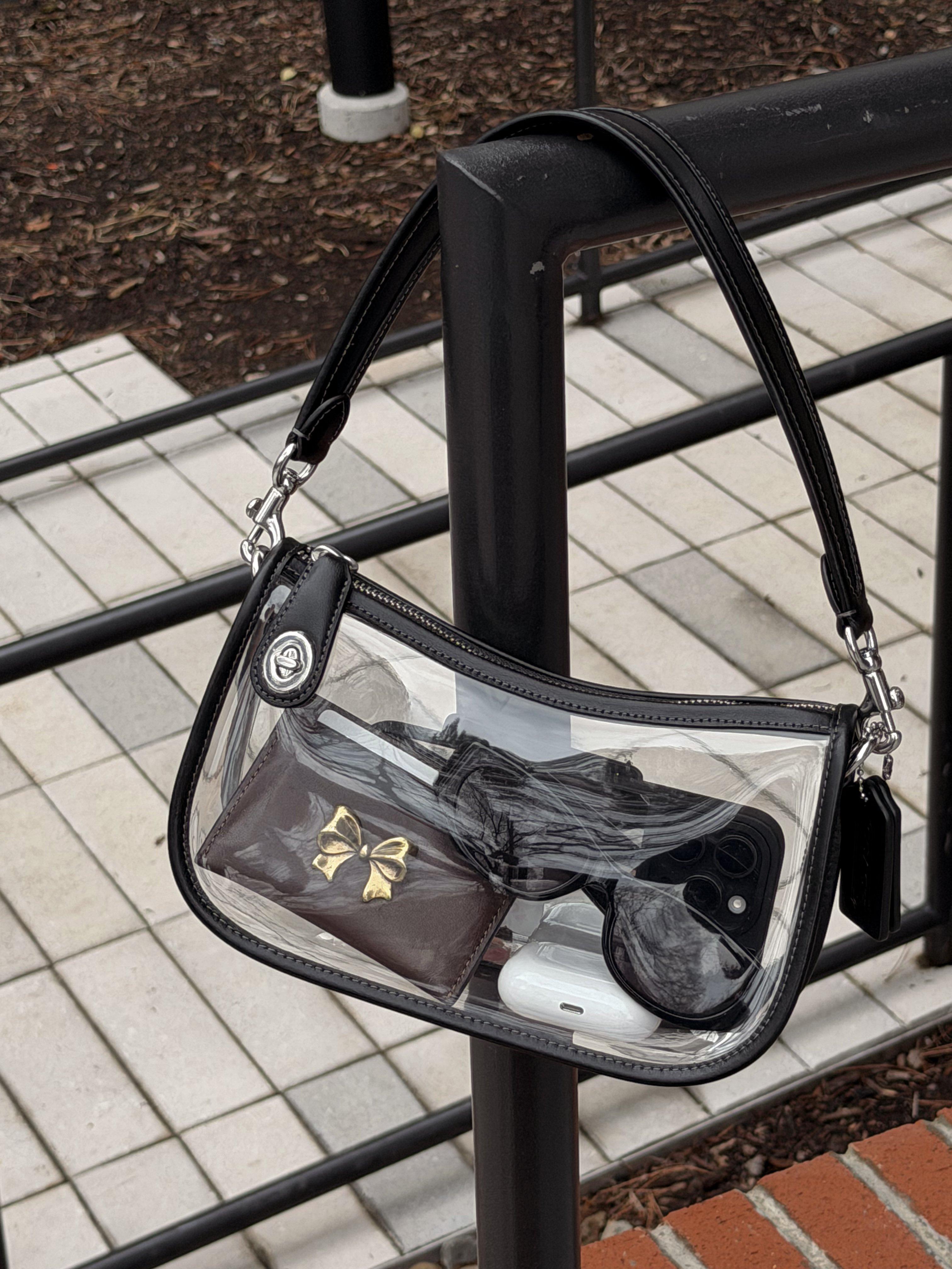 Crossbody bag worn hands-free in wet weather