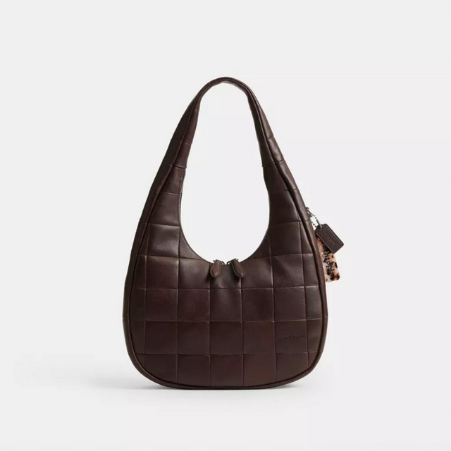 Dark brown woven leather hobo bag with quilted pattern, dual handles, and decorative tassel charm.