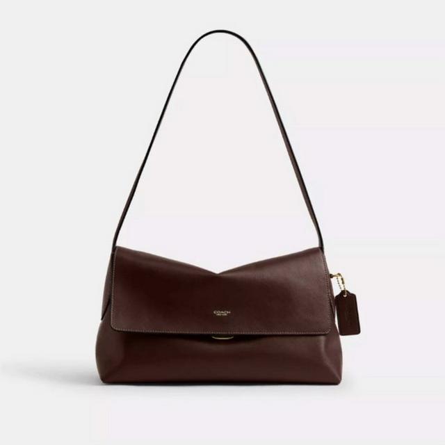 Coach brown leather shoulder bag with flap closure and adjustable strap with logo tag.