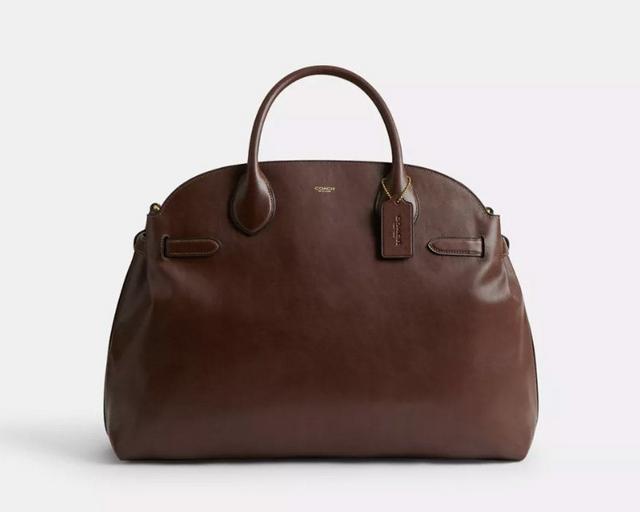 Brown leather dome-shaped handbag with dual handles and detachable shoulder strap.