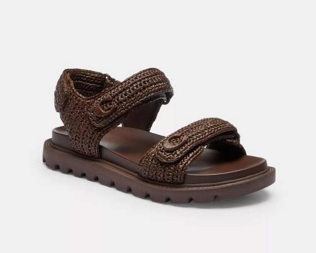 Brown woven strap sandal with dual hook-and-loop closures and chunky treaded sole.