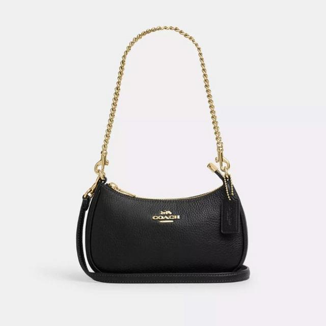 Coach black leather mini shoulder bag with gold chain strap and crossbody strap.
