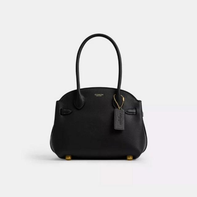 Coach black leather shoulder bag with drawstring closure, gold hardware, and brand tag.