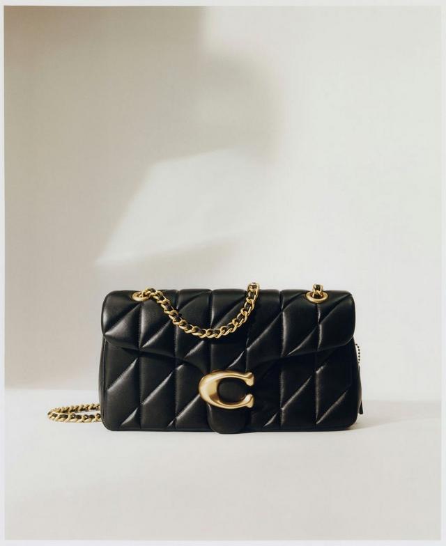 a black quilted bag with gold chain