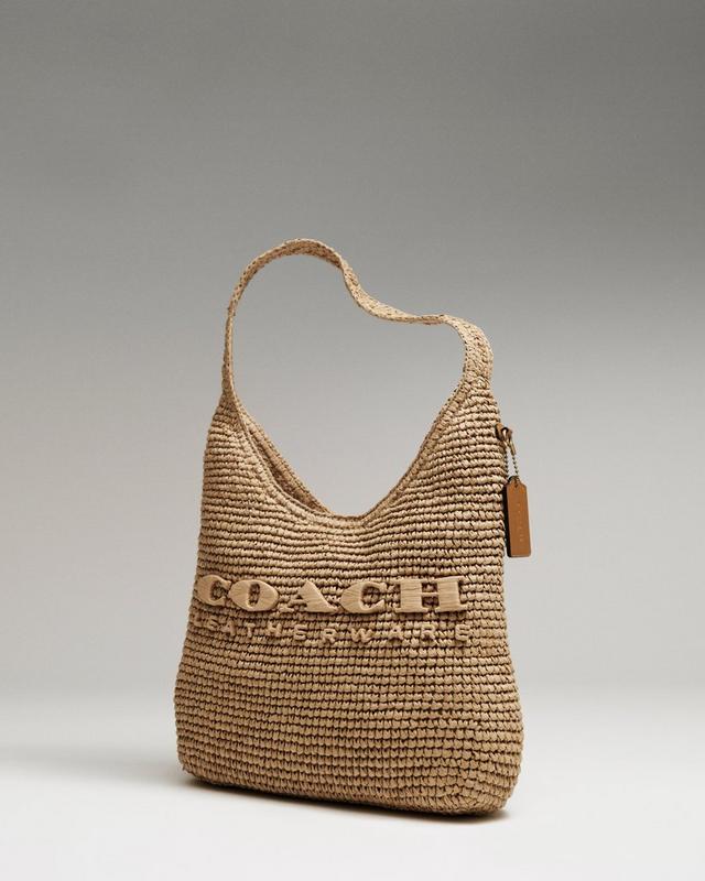 a brown purse with the word coach written on it