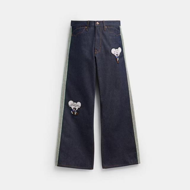 Dark denim wide-leg jeans with side stripes and cartoon character patches.