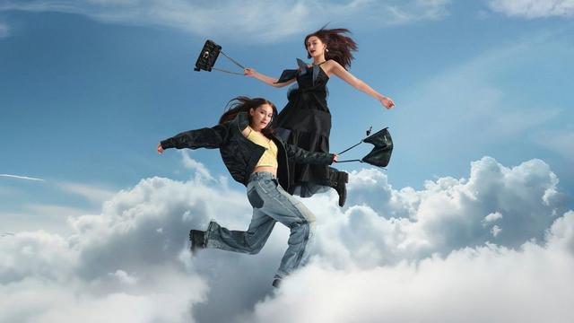 two women are flying through the air with umbrellas