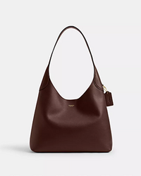 Dark brown leather hobo shoulder bag with a single curved handle and tassel detail.