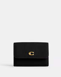 Black leather wallet with gold-tone Coach logo hardware on front flap closure.