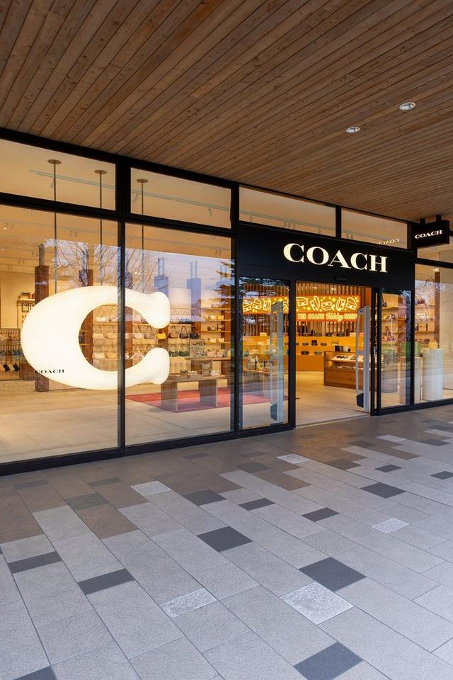 a coach store with a large sign on the front