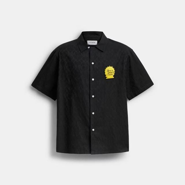 A classic-fit black camp shirt crafted from cotton, featuring an eye-catching sunhead patch.