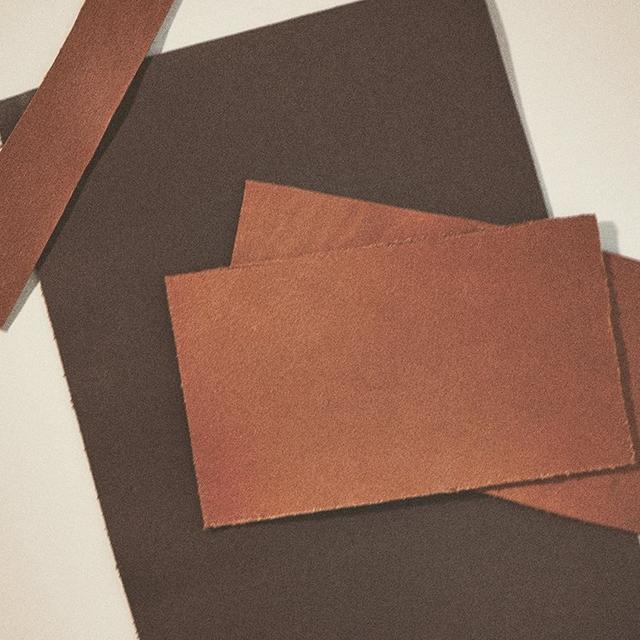 Assorted brown and gray sandpaper sheets arranged in an overlapping composition.